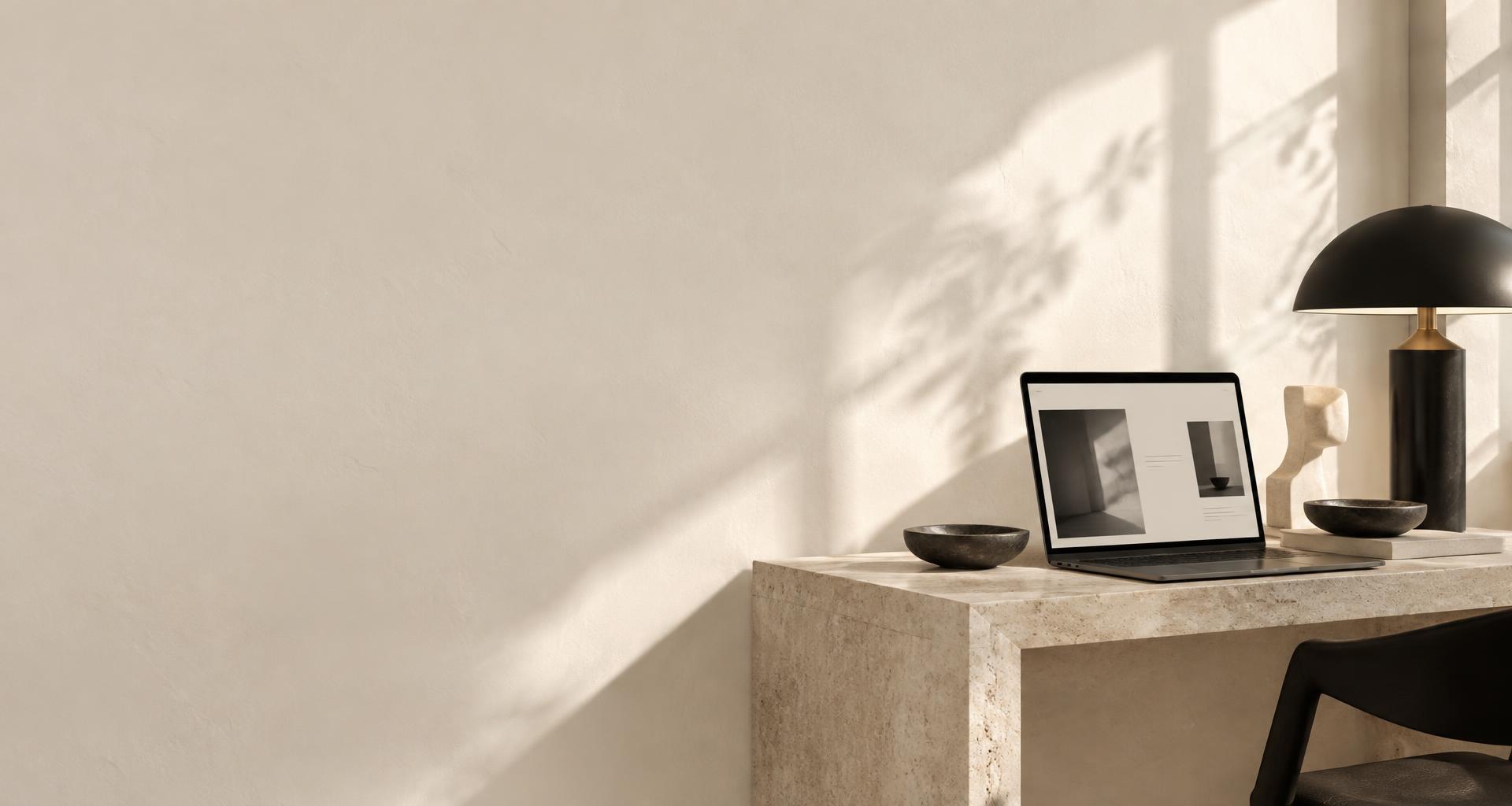 A sunlit creative studio with a website displayed on a laptop